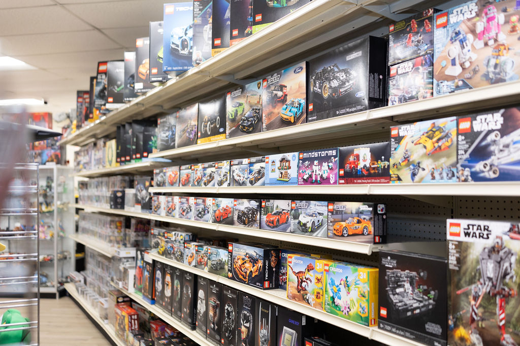 A long aisle of LEGO sets filling the shelves at The Toy Outpost in Edgewater, Maryland.