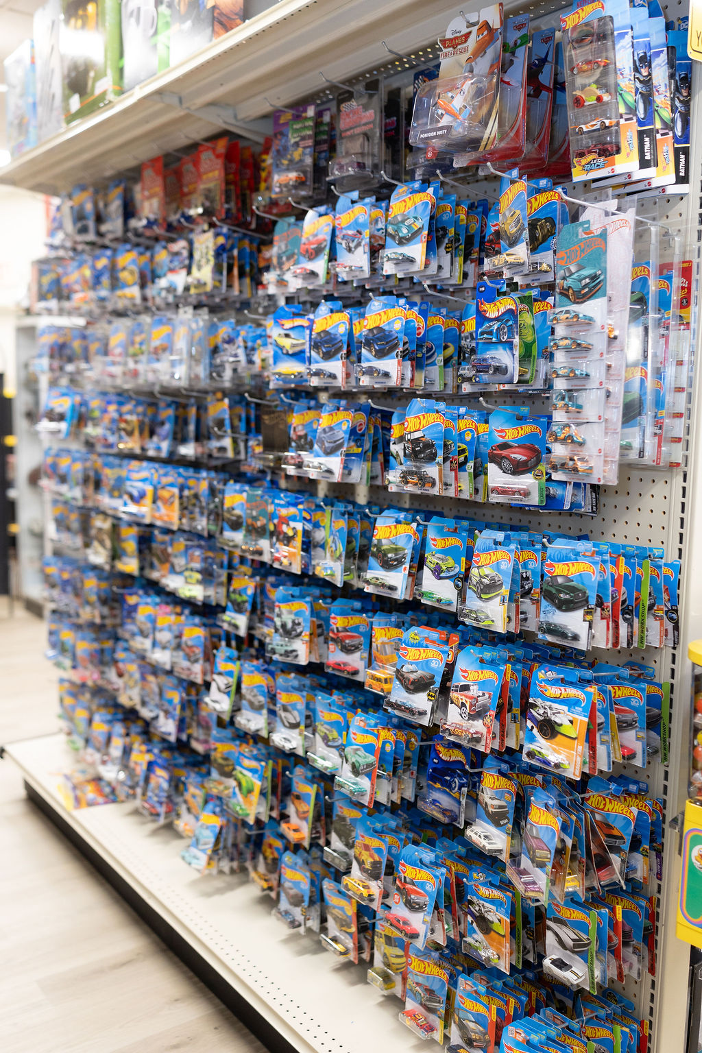 Floor-to-ceiling Hot Wheels peg wall at The Toy Outpost.
