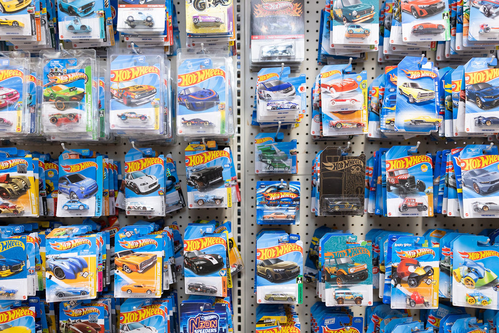 A pegboard wall packed with Hot Wheels cars.