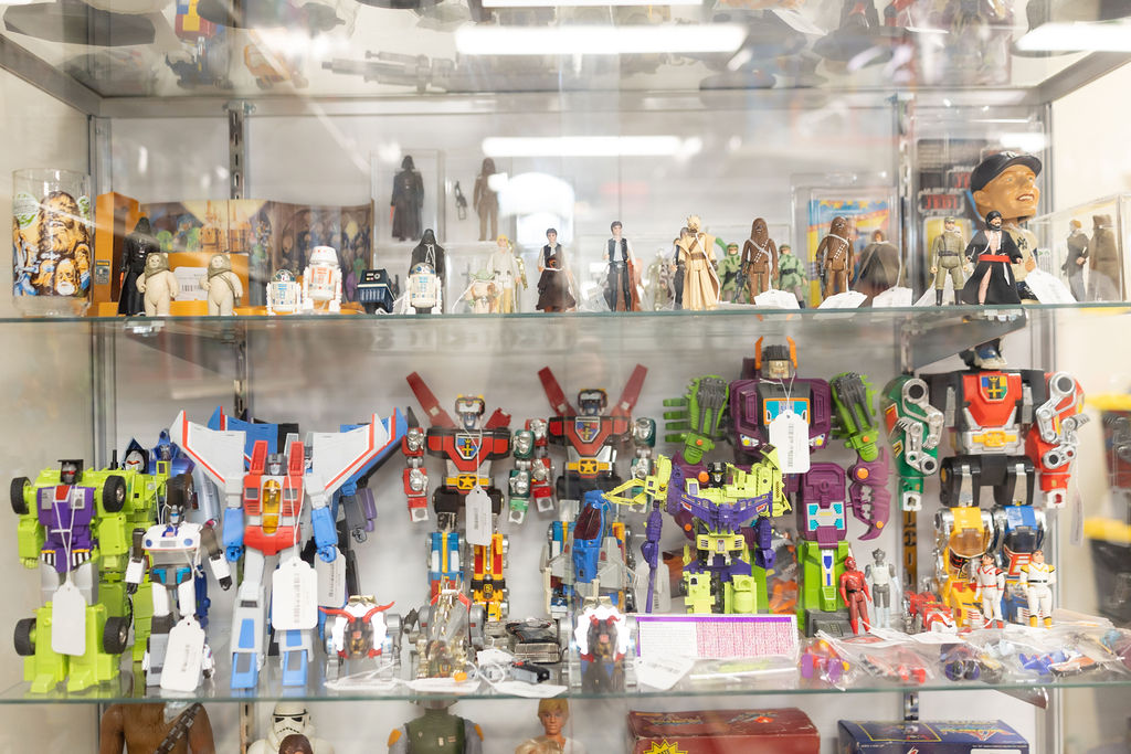 A glass case of loose action figures and collectibles.