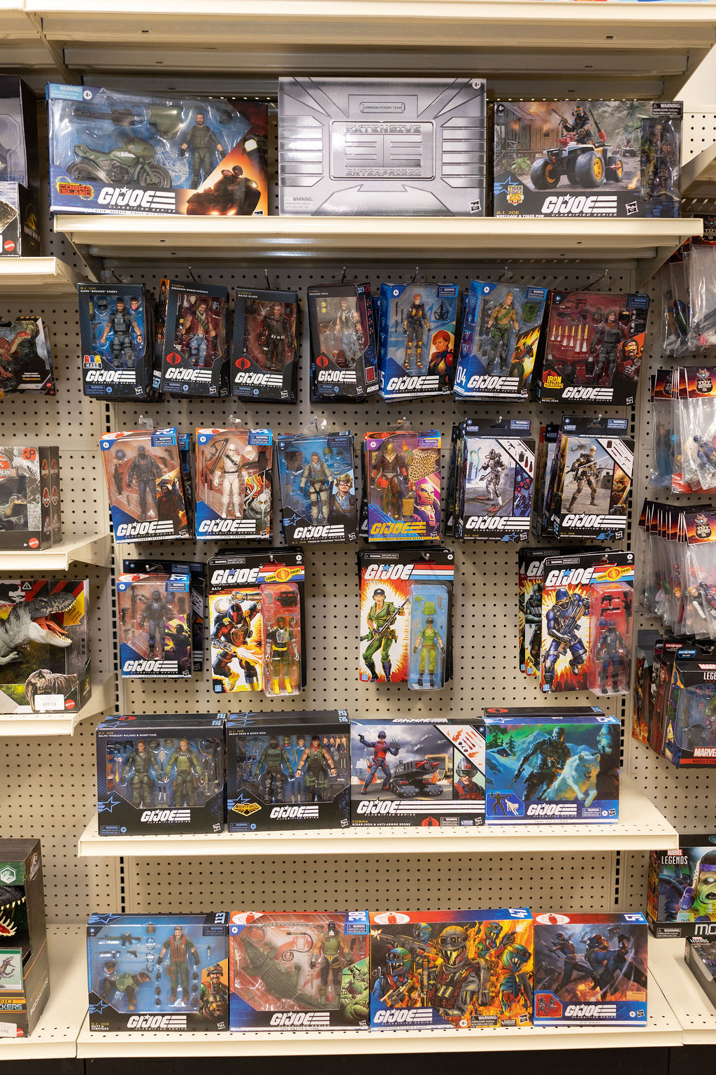 Vintage G.I. Joe figures and vehicles on the shelf.