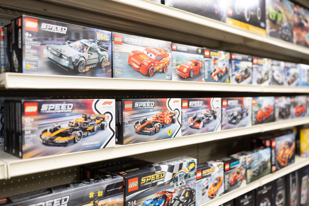LEGO Speed Champions race cars on the shelf, including Formula 1 sets.