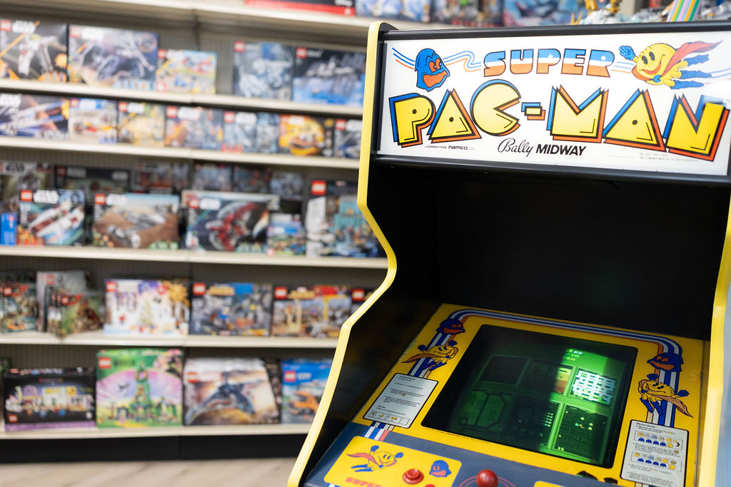 A free-play Super Pac-Man machine on the shop floor at The Toy Outpost.